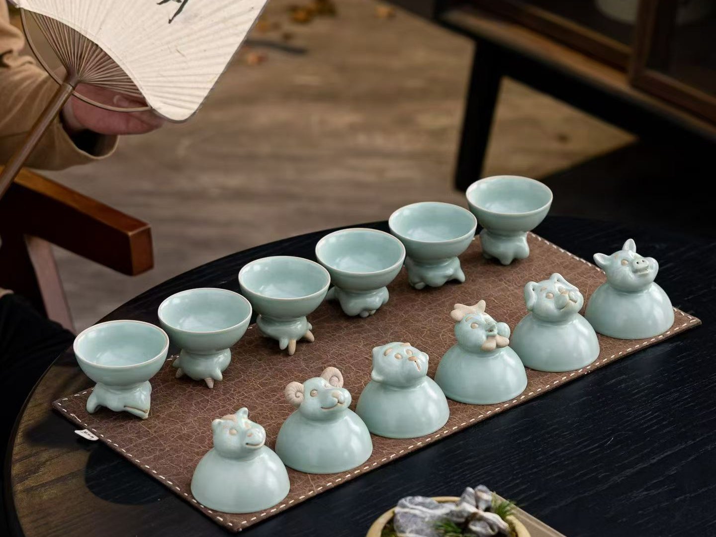 Chinese zodiac porcelain cups and figures arranged for a private Beijing cultural experience