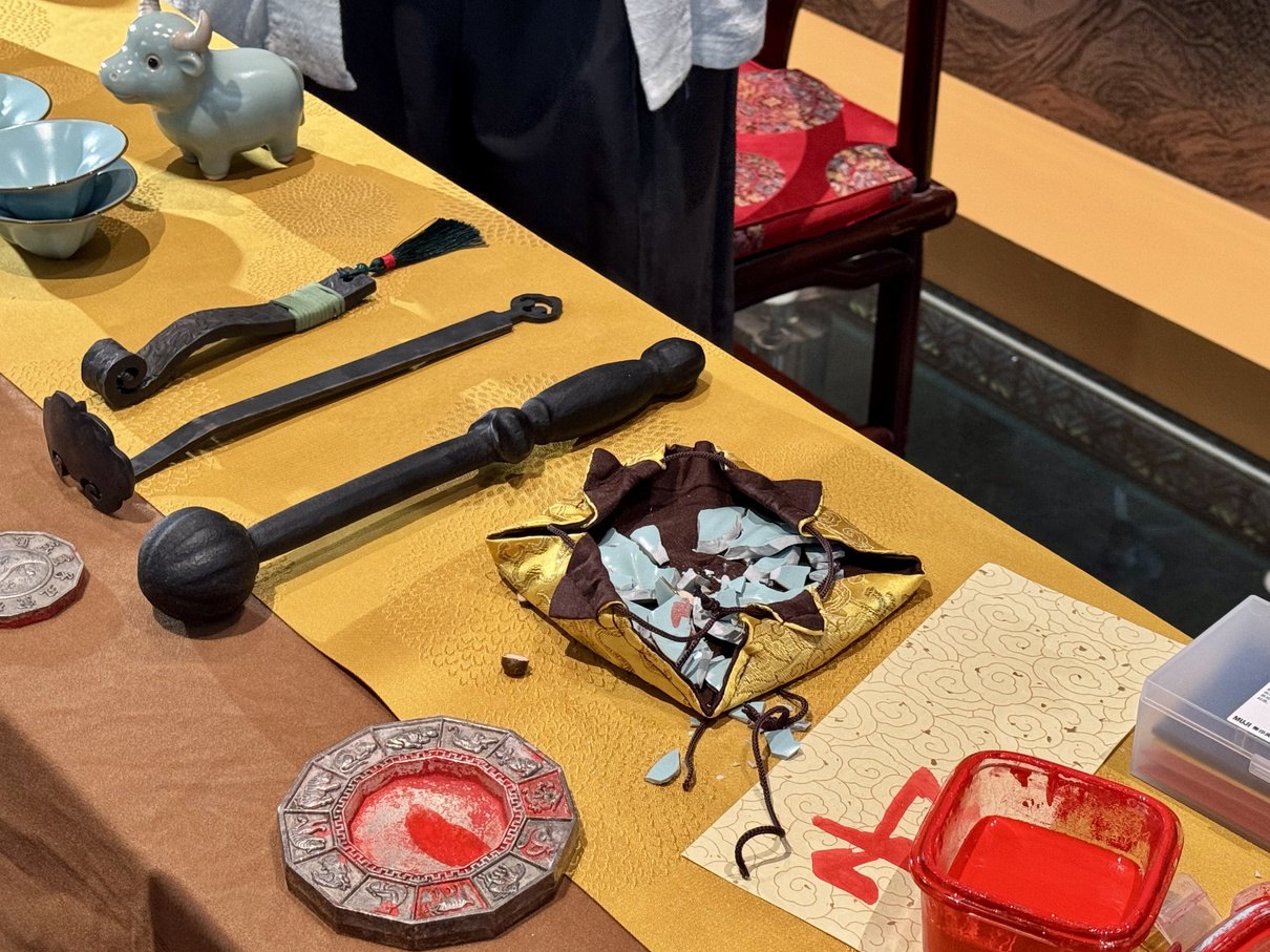 Porcelain pieces and traditional activity tools arranged for a symbolic closing ritual