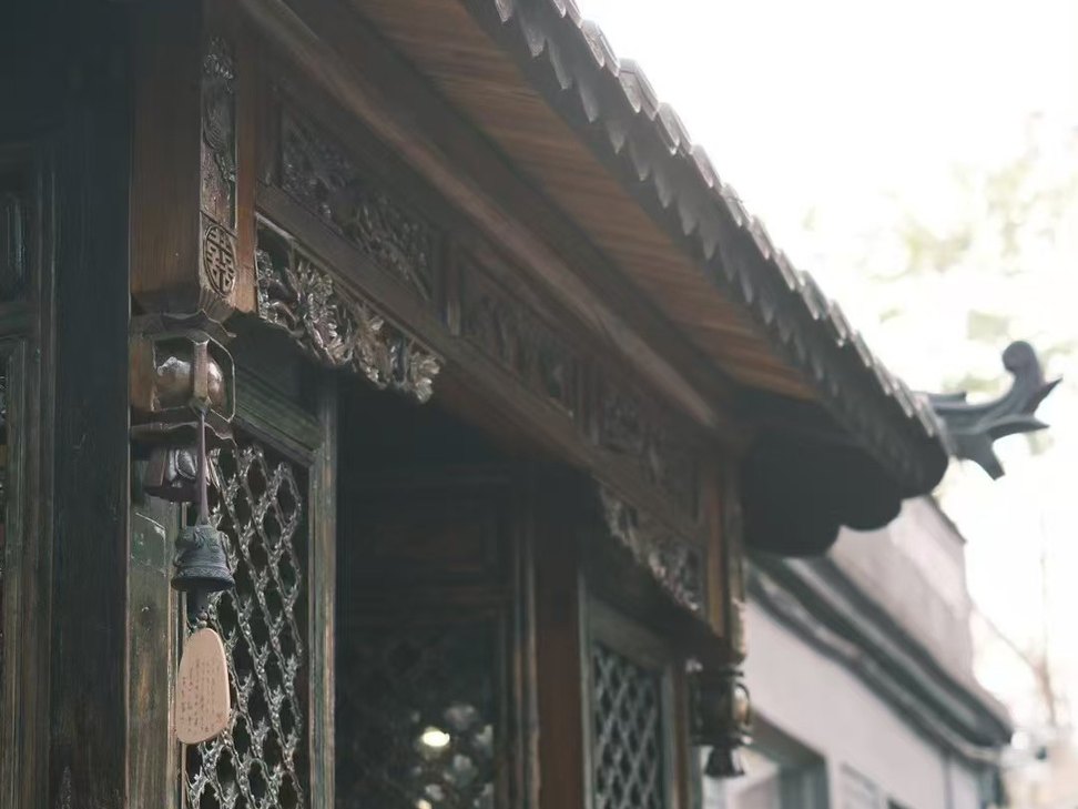 Carved timber entrance at a traditional private courtyard near Houhai