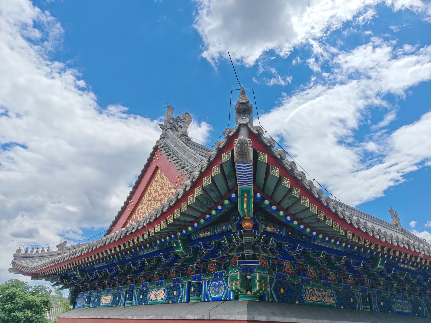 Decorated temple roof beneath a wide blue sky in Beijing’s Western Hills