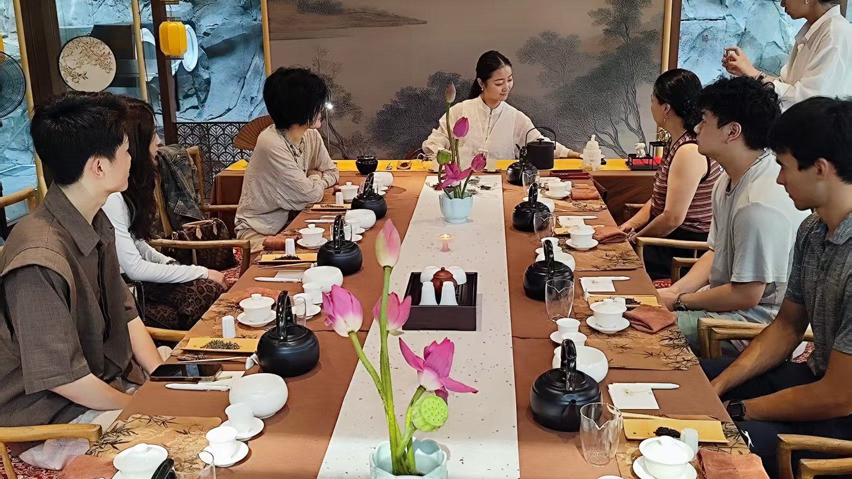 International guests joining a private Chinese tea tasting in a Beijing cultural setting