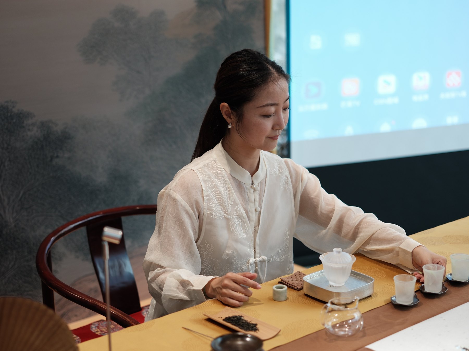 Tea host demonstrating Chinese tea preparation