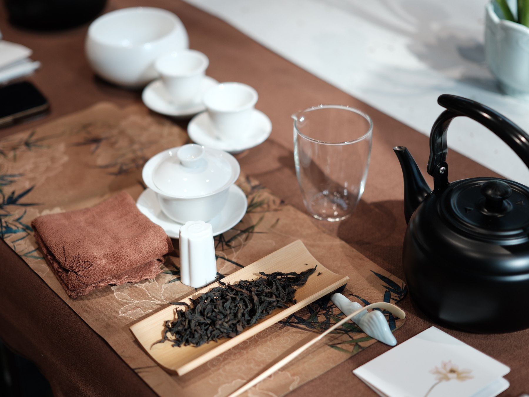 Chinese tea leaves, teaware, and brewing equipment prepared for a guest