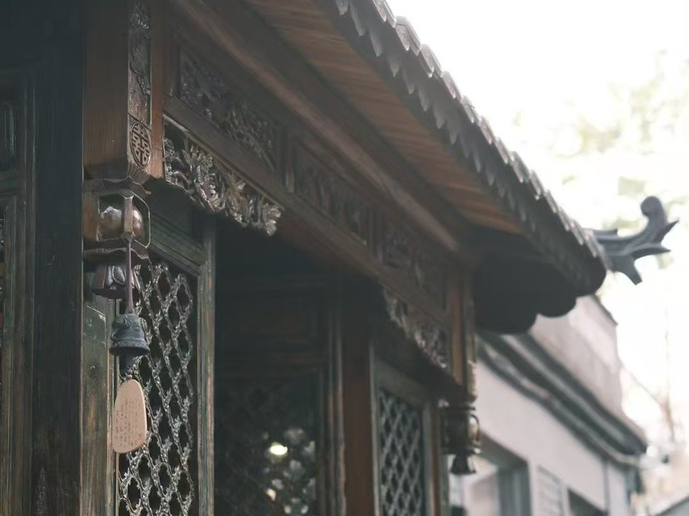 Carved timber entrance at a traditional private courtyard near Houhai