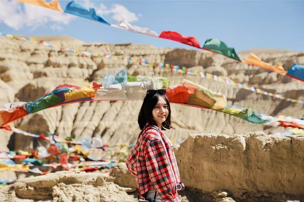 A traveler in western China surrounded by colorful cultural landscape