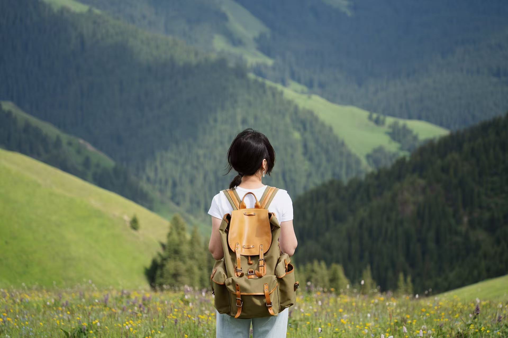 A traveler looking across western China grasslands as part of a tailor-made journey